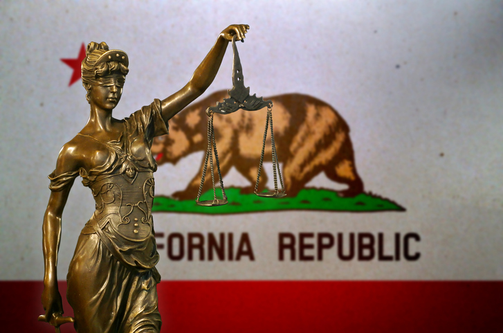 Lady Justice before a flag of California