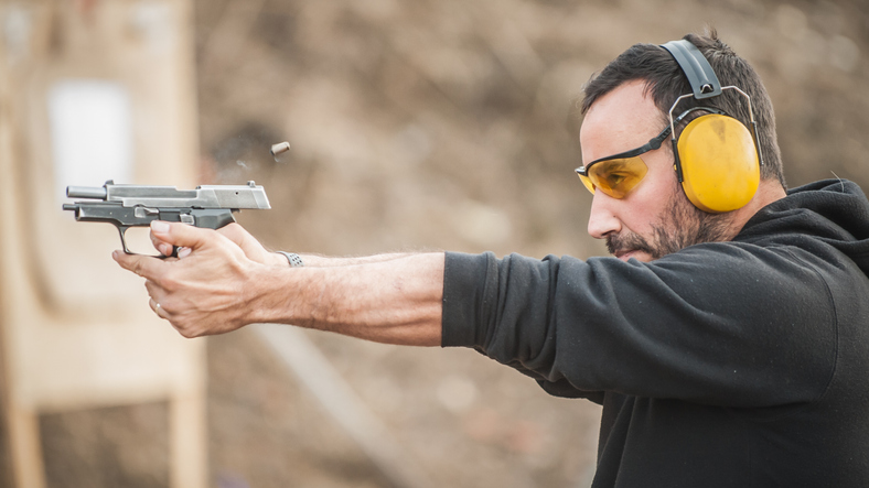 Shooter holding gun and training 