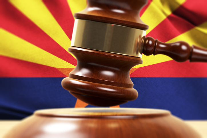 Gavel with Arizona state flag in the background